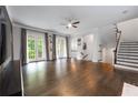 Expansive living room with hardwood floors, French doors, and elegant staircase at 3130 Woodwalk Se Trce # 8, Atlanta, GA 30339