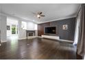 Spacious living room featuring hardwood floors, a fireplace, and a modern media center at 3130 Woodwalk Se Trce # 8, Atlanta, GA 30339