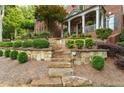 Stone steps lead up to this gorgeous home, surrounded by neatly trimmed bushes and manicured landscaping at 3750 Maryhill Nw Ln, Kennesaw, GA 30152