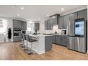 Modern kitchen with gray cabinets, a large center island, and stainless steel appliances at 776 Clifftop Xing Xing, Powder Springs, GA 30127