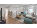 Cozy upstairs living room with comfortable seating and a modern design at 776 Clifftop Xing Xing, Powder Springs, GA 30127