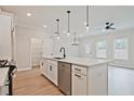Contemporary kitchen featuring a large island, stainless steel dishwasher, and pendant lighting, adding a touch of elegance at 174 Bluffington Way, Marietta, GA 30066