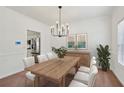 Elegant dining room with modern chandelier and a large wooden dining table with seating for six at 1955 Pius Dr, Ellenwood, GA 30294