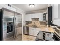 Well-lit kitchen featuring stainless appliances, granite counters, and tile backsplash at 286 Indian Trl, Marietta, GA 30068