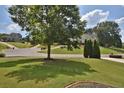 Residential neighborhood featuring well-maintained homes and green spaces under a sunny sky at 6425 Riley Manor Way, Cumming, GA 30028
