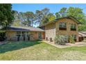 Charming brick home with a manicured lawn and decorative potted plants framing the entrance at 3530 Embry Circle Cir, Atlanta, GA 30341