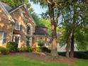 Charming brick home with well-manicured lawn and mature trees at 365 Falling Creek Bnd, Duluth, GA 30097