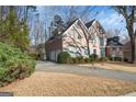 Elegant brick home boasting a private driveway, lush greenery, and a stately facade at 365 Falling Creek Bnd, Duluth, GA 30097