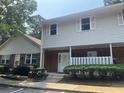 Shot of the exterior of a two-story townhouse with neutral siding and brick facade at 5950 Wintergreen Rd, Norcross, GA 30093