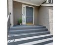 Charming front door entryway with grey door, painted stairs, and stylish potted greenery at 36 Saint Claire Ne Ln, Atlanta, GA 30324