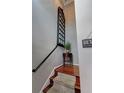 Carpeted staircase with wooden floors, decorative window pane, and charming accent table at 36 Saint Claire Ne Ln, Atlanta, GA 30324