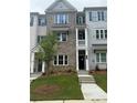 Stylish townhouse with a well-maintained lawn and attractive architectural details in a friendly neighborhood at 1956 Deco Dr, Kennesaw, GA 30144
