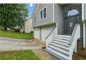 Close up of house showing entryway with stone accents, gray siding and white trim at 11020 Knotty Pine Pl, Hampton, GA 30228