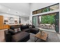 Open concept living room and kitchen area, with modern furniture and access to outdoor dining space at 1544 Bullard Rd, Powder Springs, GA 30127