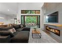 Bright living room features a linear fireplace, modern furniture, and sliding glass doors to the exterior at 1544 Bullard Rd, Powder Springs, GA 30127