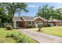 Single-story brick house with a carport and a long driveway, nestled among mature trees at 2855 Monticello Pl, Decatur, GA 30030