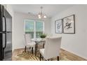 A dining area is lit by a chandelier and has a zebra rug under the table at 3516 Waldrop Trl, Decatur, GA 30034