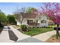 Charming home featuring a landscaped yard, inviting porch, and updated driveway at 102 Rockyford, Atlanta, GA 30317