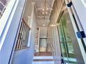 Bright entryway features modern chandelier and stylish front door at 285 Briscoe Way # 2, Alpharetta, GA 30009