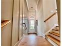 Stylish entryway features hardwood floors and elegant staircase at 285 Briscoe Way # 2, Alpharetta, GA 30009