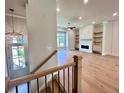 Bright and airy living room features a fireplace, built-in shelves, and hardwood floors at 285 Briscoe Way # 2, Alpharetta, GA 30009