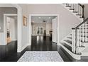 Welcoming foyer with dark hardwood floors, a staircase with white spindles, and an open view to the living spaces at 4030 River Ridge Se, Marietta, GA 30067