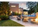 Landscaped backyard with a pool, fire pit, and outdoor seating area at 1242 Wild Creek Ne Trl, Atlanta, GA 30324