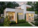 Modern two-story home featuring a garden and stone steps leading to the front door at 1242 Wild Creek Ne Trl, Atlanta, GA 30324