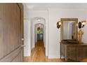 Inviting foyer features hardwood floors, decorative mirror, and arched doorways at 130 Timber Oak Cv, Lawrenceville, GA 30043