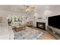 Bright living room with a fireplace, decorative rug, and ample seating at 130 Timber Oak Cv, Lawrenceville, GA 30043