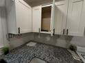 Close-up of kitchen with white cabinets, granite countertops, and modern hardware at 186 W Lake Nw Dr, Atlanta, GA 30314