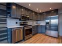 Modern kitchen featuring stainless steel appliances, light countertops and gray cabinets at 215 Piedmont Ne Ave # 804, Atlanta, GA 30308