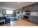 Open living area with a blue couch, stainless steel kitchen, and lots of natural light at 215 Piedmont Ne Ave # 804, Atlanta, GA 30308