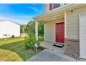 Inviting front porch and red door enhance the curb appeal of this well-maintained home at 3 Windsor Ct, Kingston, GA 30145