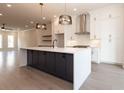 Spacious kitchen with a large island, stainless steel vent hood, and modern pendant lights at 530 Fisher Dr # 45, Alpharetta, GA 30009