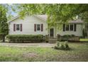 Charming one-story home with light-colored siding, red shutters, and mature landscaping at 291 N Briar Rdg, Woodstock, GA 30189