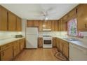Functional kitchen featuring wood cabinets, white appliances, and a bright, clean space at 291 N Briar Rdg, Woodstock, GA 30189