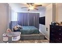 Comfortable bedroom features a large bed, plush carpeting, and a ceiling fan at 3060 Pharr Court North Nw # 719, Atlanta, GA 30305