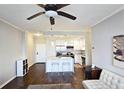 An open concept features a well-lit kitchen with stainless steel appliances and marble countertops at 3060 Pharr Court North Nw # 719, Atlanta, GA 30305