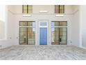 Modern entryway features blue door, tile flooring, and views into kitchen and living room at 260 Guild Ln, Fayetteville, GA 30214