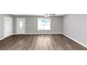 Bright living room with modern wood floors, neutral paint, and lots of light at 409 Ivy Terrace Dr, Dallas, GA 30157