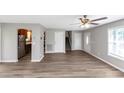 Open-concept living area featuring stylish laminate flooring and a ceiling fan at 409 Ivy Terrace Dr, Dallas, GA 30157