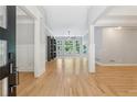 Bright living room featuring hardwood floors, built-in shelving, and large windows with lots of natural light at 148 Copper Hills Dr, Canton, GA 30114