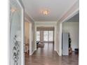 Inviting foyer with hardwood floors and a view into the living area through an elegant door at 2005 Ashton Pointe Dr, Dacula, GA 30019