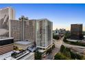 Wide aerial shot capturing city buildings and streets, with lush trees and clear skies at 215 Piedmont Ne Ave # 2208, Atlanta, GA 30308