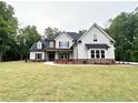Beautifully landscaped two-story home with stone accents, dormer windows, and a welcoming front yard at 169 West Lake Blvd, Carrollton, GA 30116