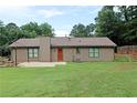 Expansive backyard featuring a well-maintained lawn, patio area, garden space, and privacy fencing at 199 Candy Ln, Canton, GA 30115