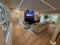 Spacious living room with hardwood floors, fireplace, modern lighting, and view of dining area at 2413 N. Decatur Rd, Decatur, GA 30033