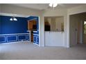 Open concept living space with neutral carpet, white trim and brightly painted blue accent wall at 2955 Briaroak Dr, Duluth, GA 30096