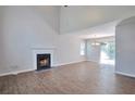 Spacious living room with hardwood floors, a fireplace, and sliding glass doors to the backyard at 4879 Ardsley Dr, Lithonia, GA 30038